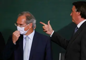 O presidente Jair Bolsonaro e o ministro Paulo Guedes, durante o lançamento do Plano Nacional de Crescimento Verde, em Brasília. | Sergio Lima / AFP